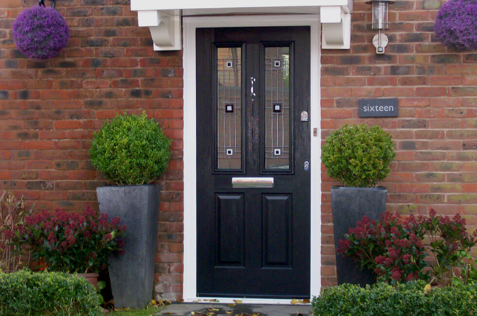 Black composite entrance door with a white frame