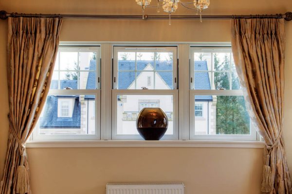 Interior view of three white uPVC vertical sliding sash windows