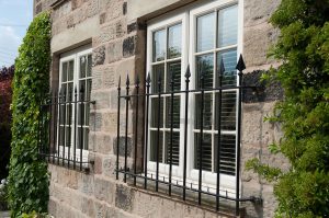 White uPVC casement windows with bars